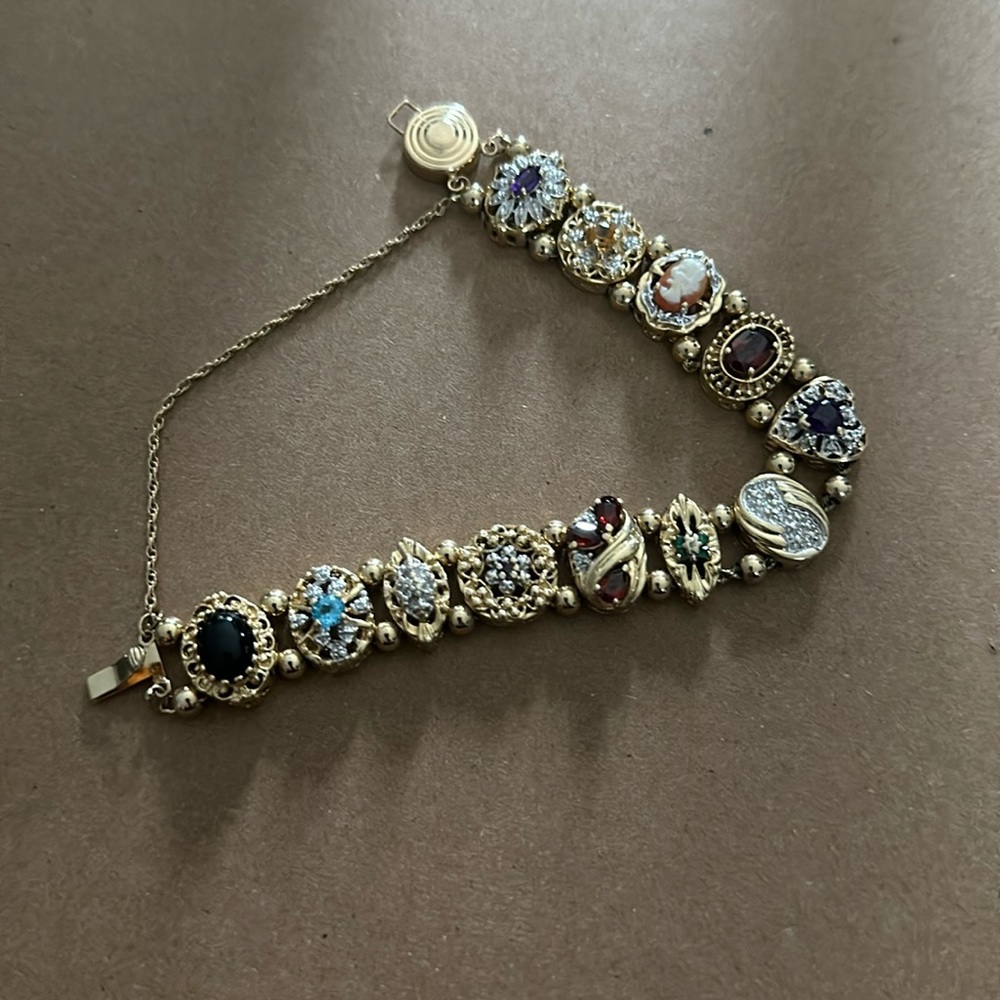 14k, 585, slider bracelet with different gems. Approximately 7 inches.